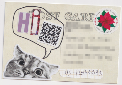 A sticker of a close up cat face partially cropped on the bottom edge of the card. A speech bubble is coming from the cat with the word 'Hi' made up of cut out magazine letters. A QR code is in the speech bubble that contains a link to a YouTube rickroll.
