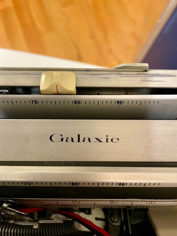 A close up of the Galaxie logo on the carriage of the machine.